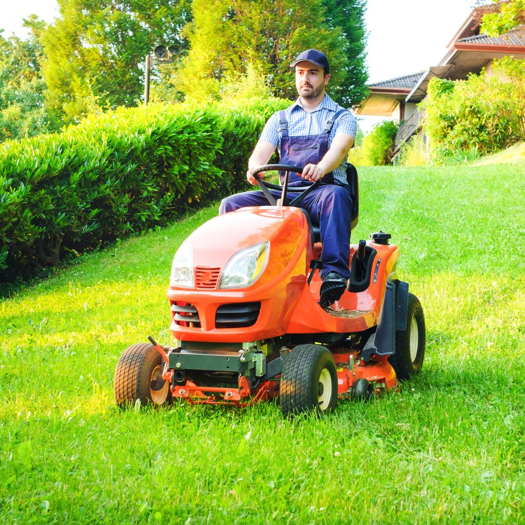 man riding lawn mower