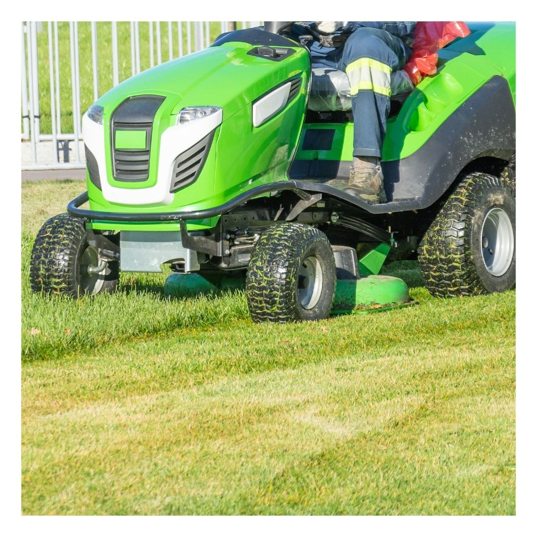 person using a riding lawn mower